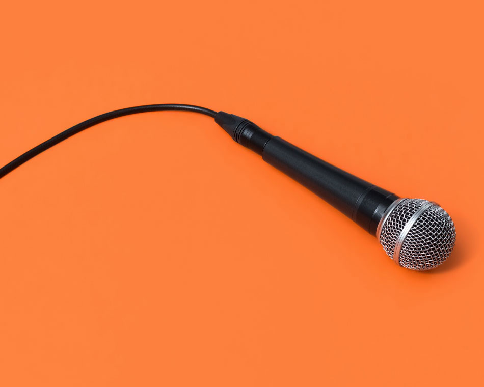 A microphone on an orange background