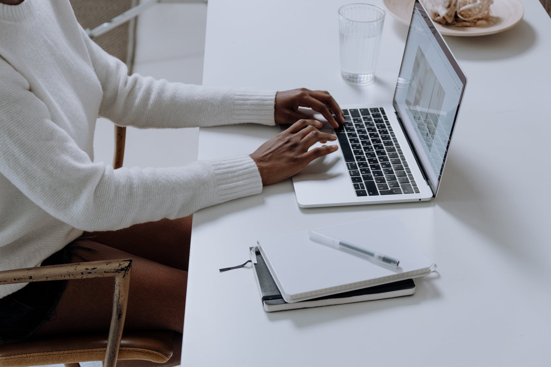 A woman writing a blog on a laptop