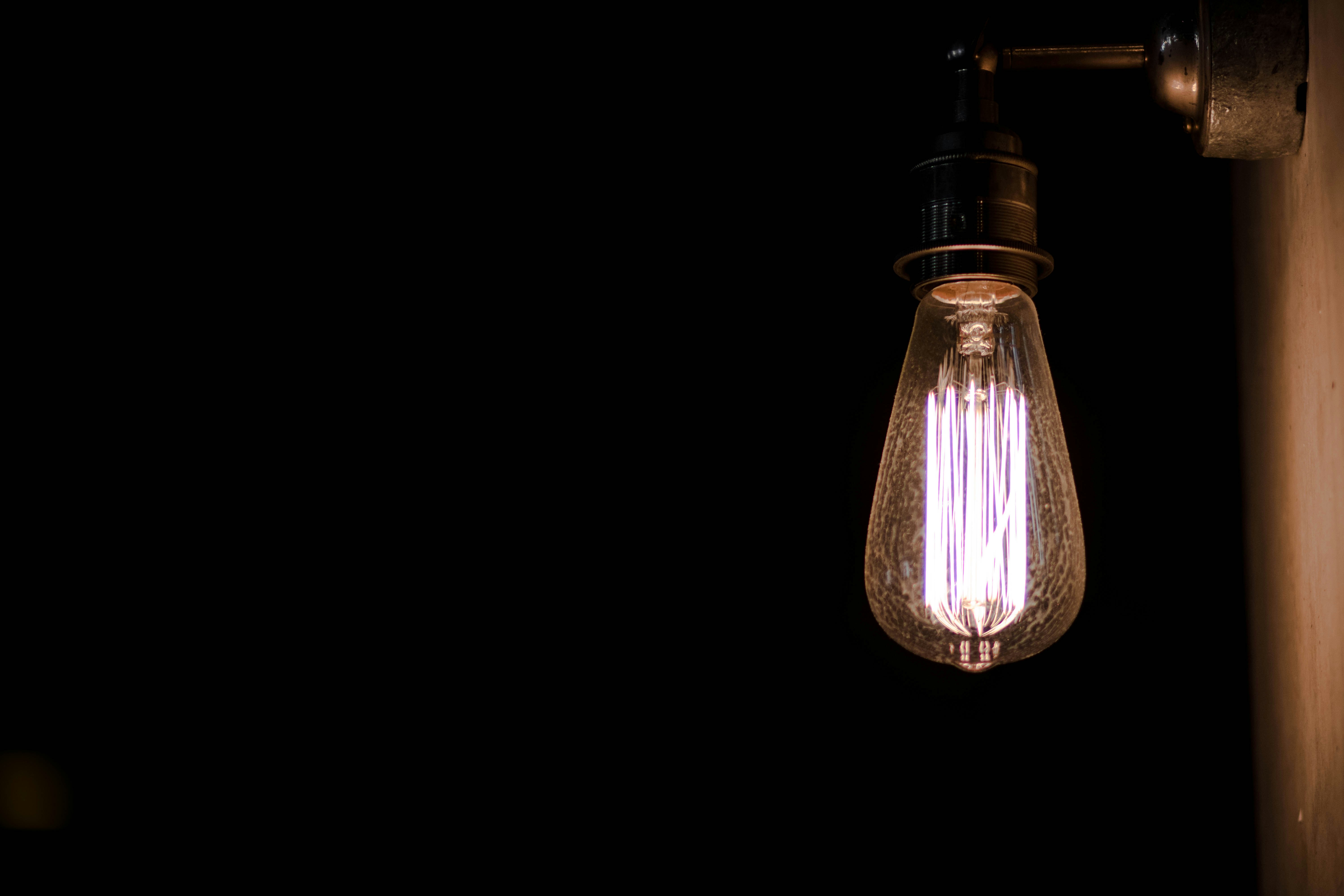 Light bulb shining in a dark room